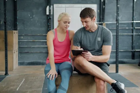 Trainer discussing a workout plan with a client