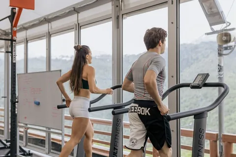 Two people training together on treadmills