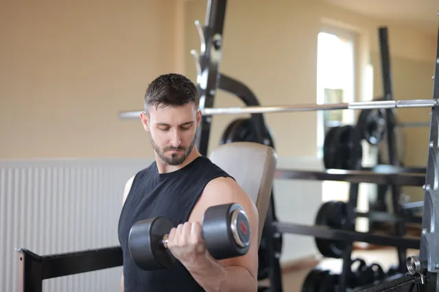 Beginner training with a dumbbell in a gym