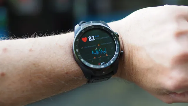 A smartwatch on a wrist showing heart rate during exercise
